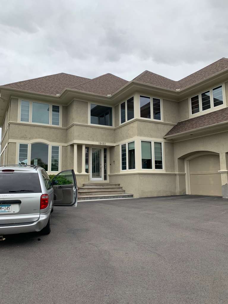 Large two-story stucco home exterior
